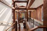 This stunning home boasts a grand entrance with exposed wooden beams, creating a warm and inviting atmosphere.