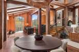 This stunning home boasts a spacious open floor plan with exposed wooden beams, creating a warm and inviting atmosphere.