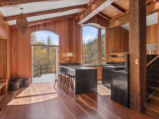 This stunning property boasts a spacious, open-concept kitchen with a large island and bar seating, perfect for entertaining.