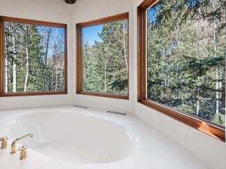 Indulge in tranquility with this luxurious bathroom boasting a spacious soaking tub, perfect for relaxation.