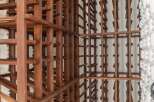 This stunning wine cellar boasts two expansive wooden racks, offering ample storage for an impressive collection.