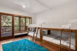This stunning bedroom features two sets of modern bunk beds, perfect for families or groups.