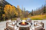 Luxury mountain retreat with a stunning outdoor fire pit perfect for enjoying the crisp autumn air.