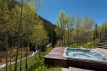 Luxury mountain retreat with private hot tub offering breathtaking views.