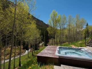 Luxury mountain retreat with private hot tub offering breathtaking views.