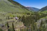 This secluded mountain estate boasts breathtaking views and offers a tranquil escape in a pristine natural setting.