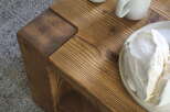 Rustic wooden coffee table with a lower shelf, perfect for a cozy living room.