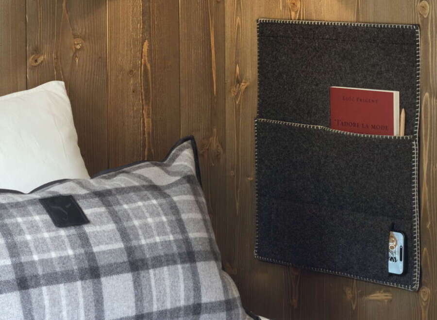 Cozy up in our rustic-chic room, featuring a plush plaid pillow and a convenient felt wall organizer.