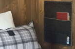 Cozy up in our rustic-chic room, featuring a plush plaid pillow and a convenient felt wall organizer.
