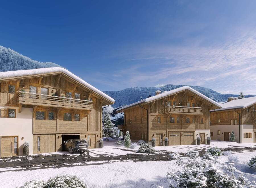 Luxury chalet homes nestled in a stunning snowy mountain setting.