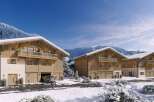 Luxury chalet homes nestled in a stunning snowy mountain setting.