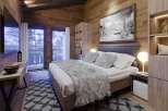 Cozy mountain cabin bedroom with stunning views.