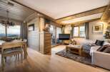 This stunning apartment boasts a spacious open-plan living area with floor-to-ceiling windows offering breathtaking mountain views.