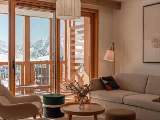 This stunning apartment boasts breathtaking mountain views from its expansive windows and private balcony.
