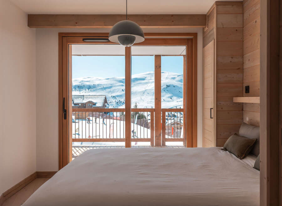 Wake up to breathtaking mountain views from this cozy bedroom.
