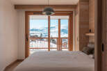 Wake up to breathtaking mountain views from this cozy bedroom.