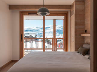 Wake up to breathtaking mountain views from this cozy bedroom.
