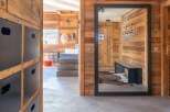 This stunning chalet boasts a spacious entryway with rustic wood walls and modern metal accents.