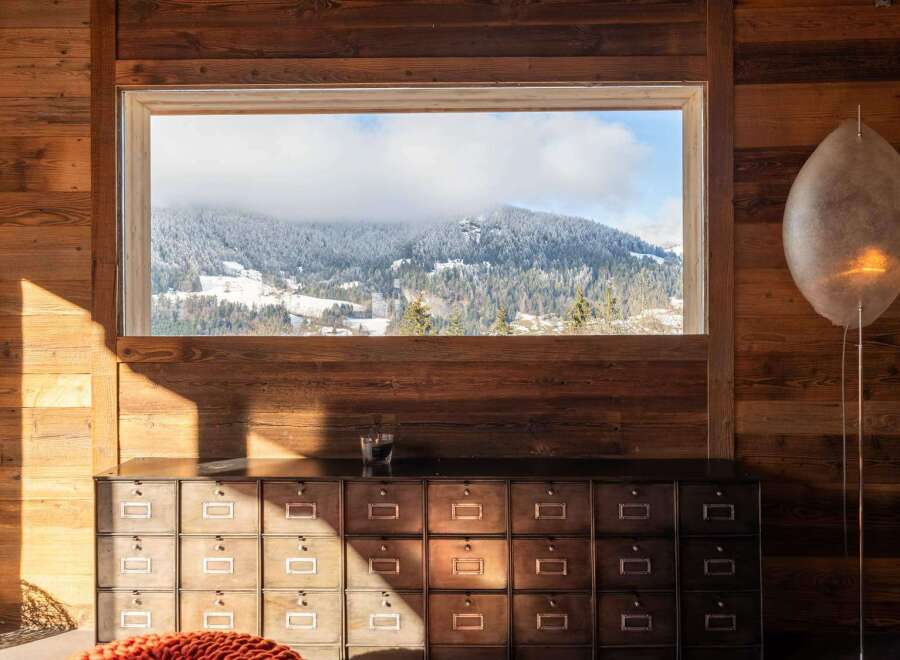 Mountain view chalet with rustic wooden walls and a unique filing cabinet.