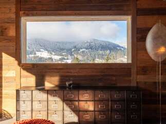 Mountain view chalet with rustic wooden walls and a unique filing cabinet.