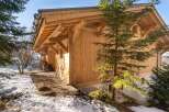 This stunning chalet boasts a beautiful wooden exterior, perfect for a cozy mountain getaway.