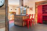 Rustic mountain kitchen with reclaimed wood finishes and red accents.