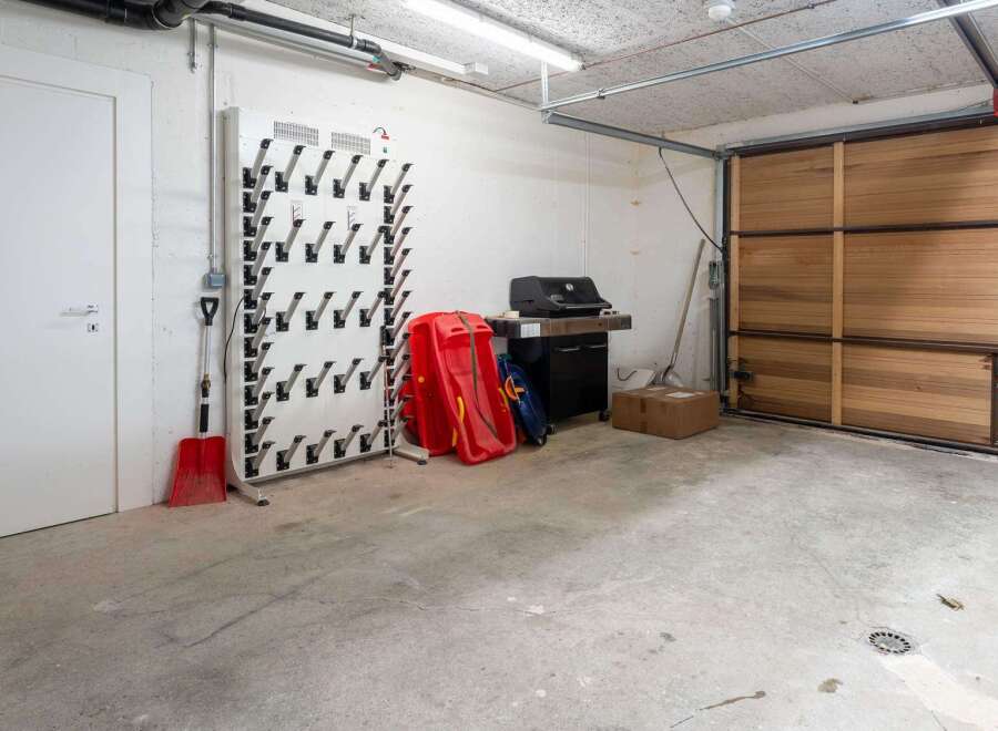 This spacious garage boasts ample storage solutions, including a dedicated boot dryer and ample space for seasonal items.