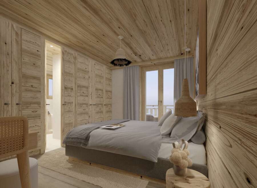 This stunning bedroom boasts a cozy and modern design, featuring a plush gray bed, wooden walls and ceiling, and large windows offering breathtaking views.