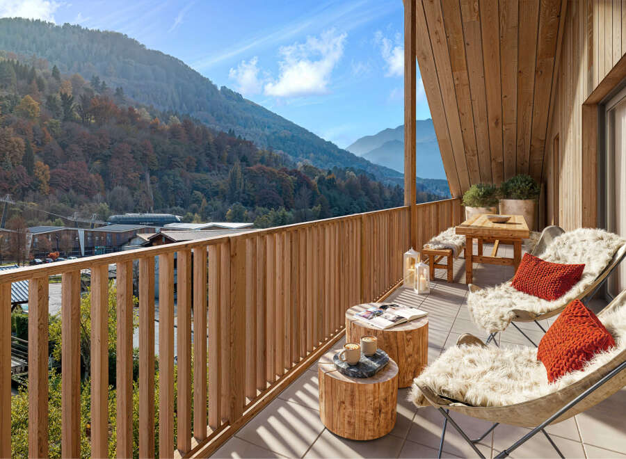 Mountain view balcony with wooden furniture and cozy seating.