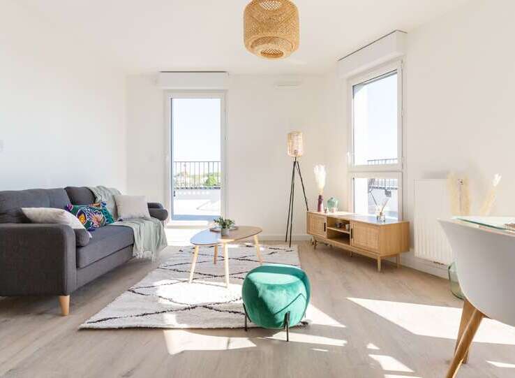 Bright and airy apartment boasting large windows offering ample natural light and stunning city views.