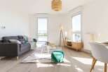 Bright and airy apartment boasting large windows offering ample natural light and stunning city views.