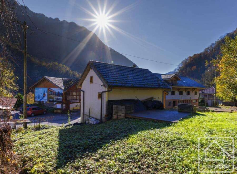 Nestled in a picturesque mountain valley, this charming property boasts a spacious barn with a large deck, perfect for outdoor entertaining.