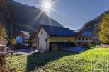 Nestled in a picturesque mountain valley, this charming property boasts a spacious barn with a large deck, perfect for outdoor entertaining.