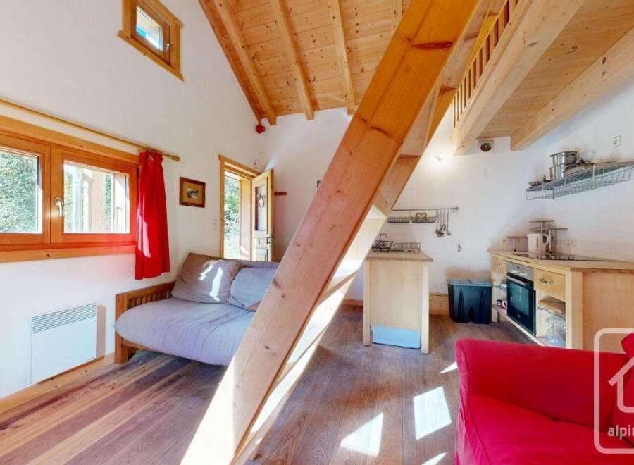 Cozy studio apartment with a lofted sleeping area, perfect for a couple's getaway.