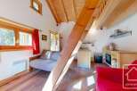Cozy studio apartment with a lofted sleeping area, perfect for a couple's getaway.