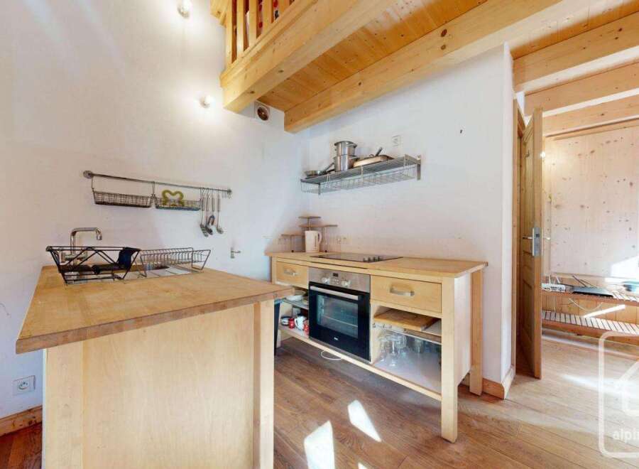 Cozy chalet kitchen with wooden cabinetry, built-in oven, and a convenient kitchen island.