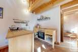 Cozy chalet kitchen with wooden cabinetry, built-in oven, and a convenient kitchen island.