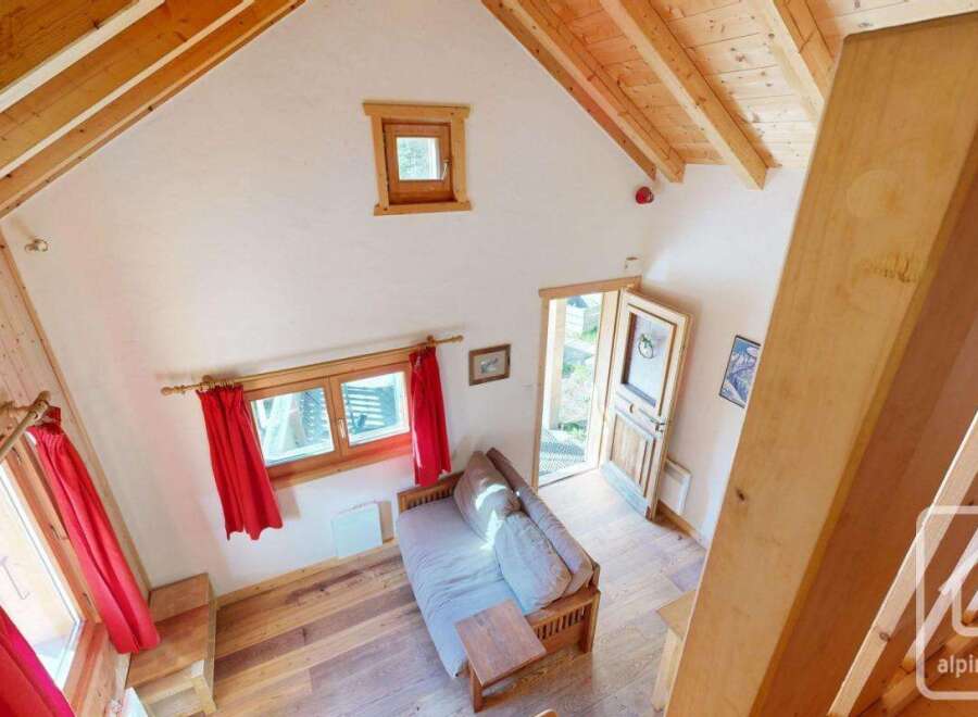 This charming chalet boasts a cozy living area with a comfortable sofa bed, perfect for relaxing after a day on the slopes.
