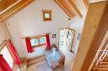This charming chalet boasts a cozy living area with a comfortable sofa bed, perfect for relaxing after a day on the slopes.