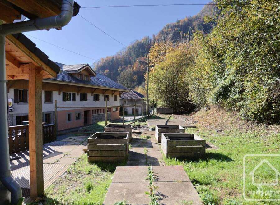 This charming property boasts a spacious garden with raised wooden planters, perfect for cultivating your favorite herbs and vegetables.