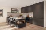 This stunning kitchen boasts a sleek, modern design with dark cabinetry and a spacious island featuring integrated storage.