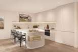 This stunning kitchen boasts a sleek, modern design with light beige cabinetry and a spacious island featuring integrated storage and a wine glass rack.