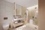 This luxurious bathroom boasts a spacious walk-in shower with a rainfall shower head and a sleek, modern vanity with ample storage.