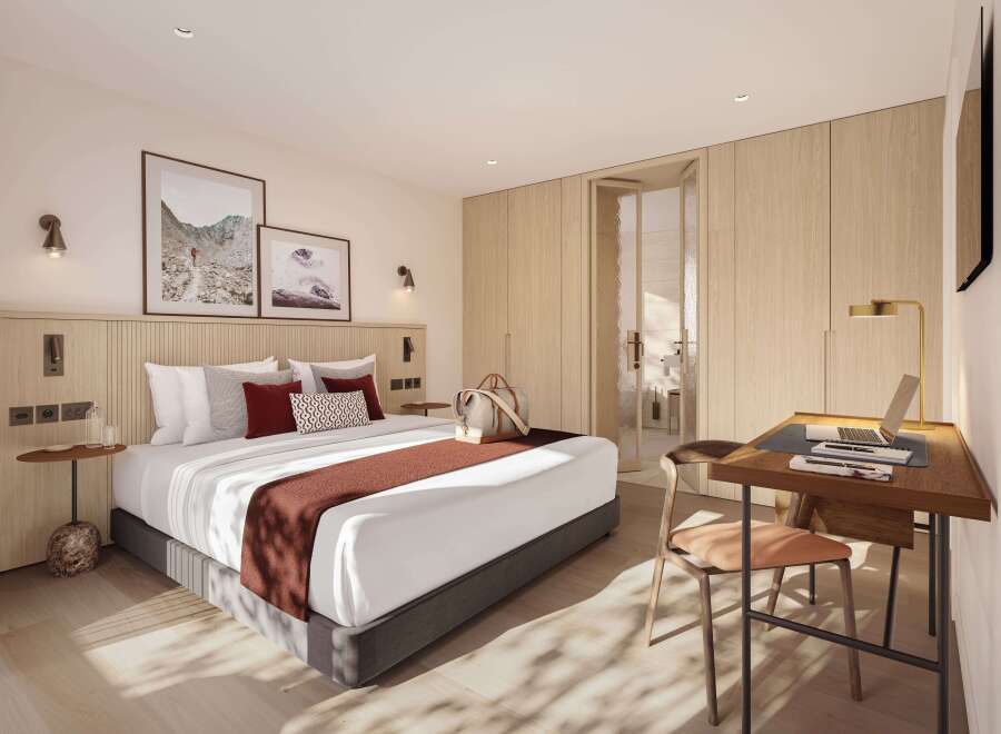 This stunning hotel room boasts a king-size bed with plush bedding, a spacious work desk with a laptop, and ample closet space.