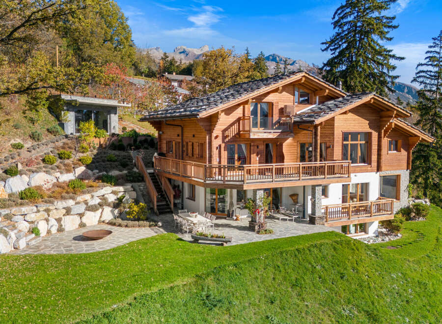 Experience luxury mountain living in this stunning wooden chalet, boasting expansive balconies with breathtaking views.