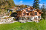 Experience luxury mountain living in this stunning wooden chalet, boasting expansive balconies with breathtaking views.