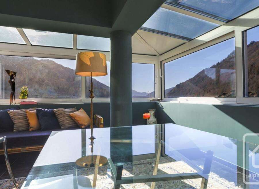 This stunning property boasts a sun-drenched conservatory with floor-to-ceiling windows offering breathtaking mountain views.
