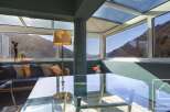 This stunning property boasts a sun-drenched conservatory with floor-to-ceiling windows offering breathtaking mountain views.