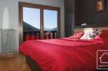 Wake up to breathtaking mountain views from this cozy bedroom, featuring a comfortable double bed and stylish decor.