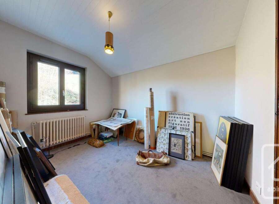 This charming attic room boasts ample natural light from its large window, creating a bright and airy atmosphere.